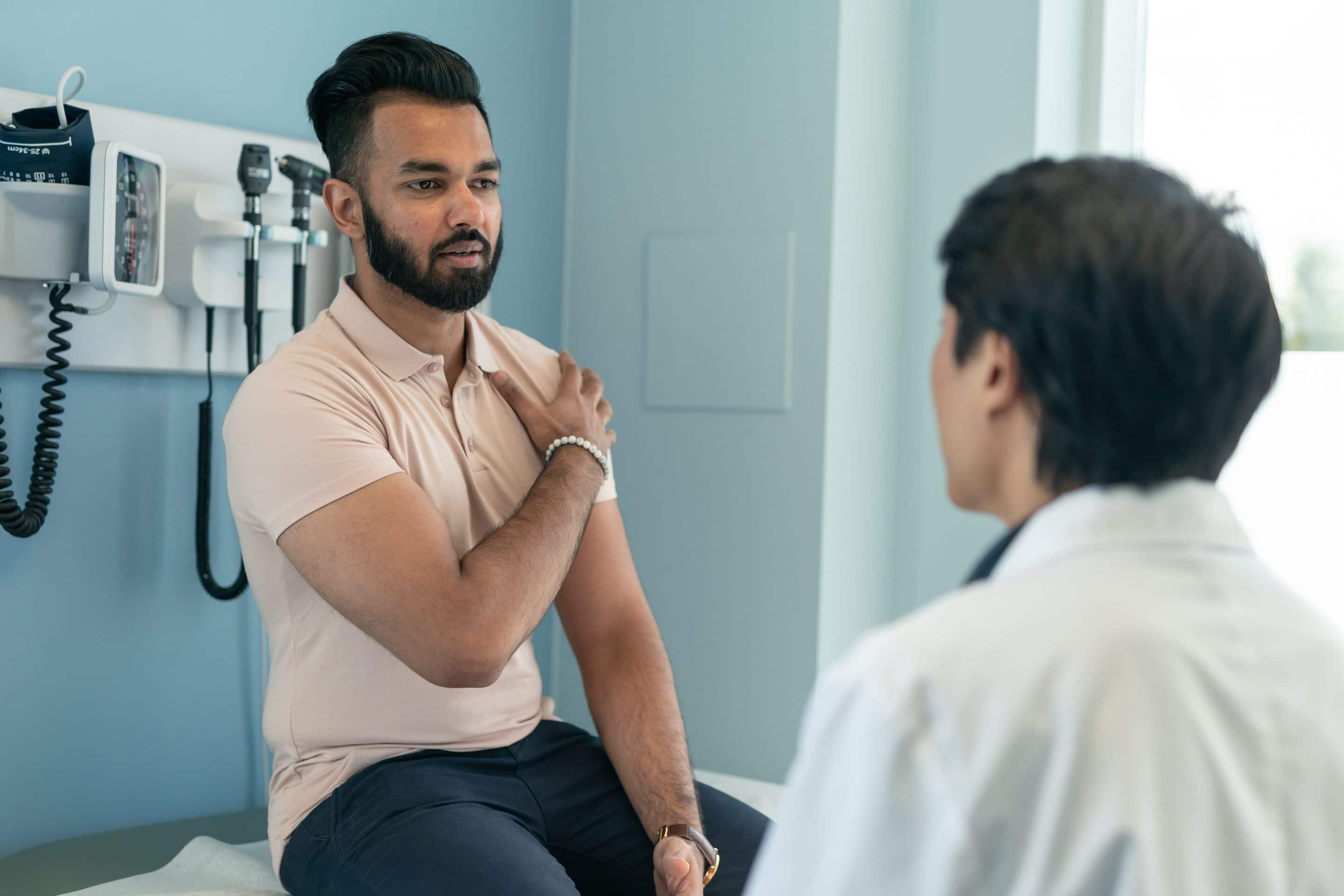 Young ethnic man in consultation with doctor